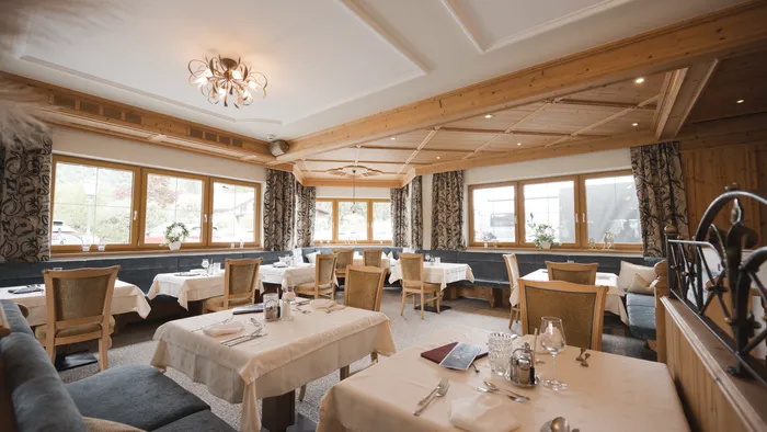 Cozy restaurant dining room with wooden decor and set tables