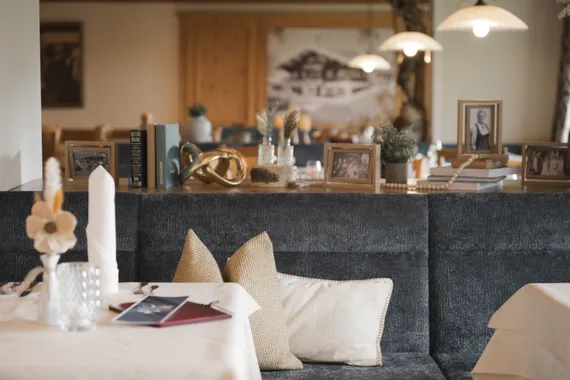 Cozy restaurant interior with decor, framed photos, and table set for dining